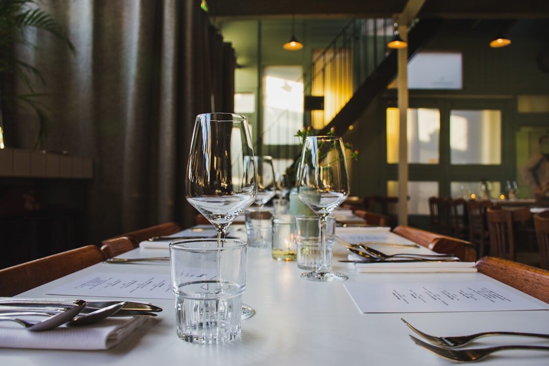 Elegant plated seafood dish on restaurant table with wine