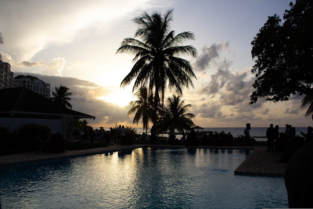 Boutique hotel pool overlooking the sea at golden hour