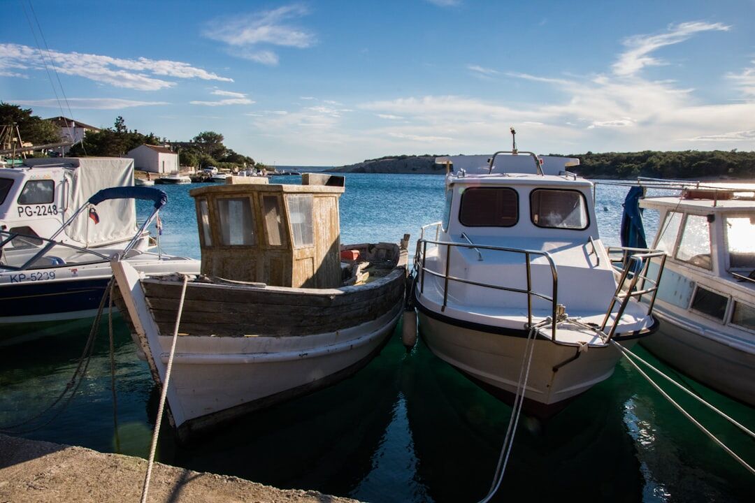 Fishing boats docked in small Croatian harbor at sunrise