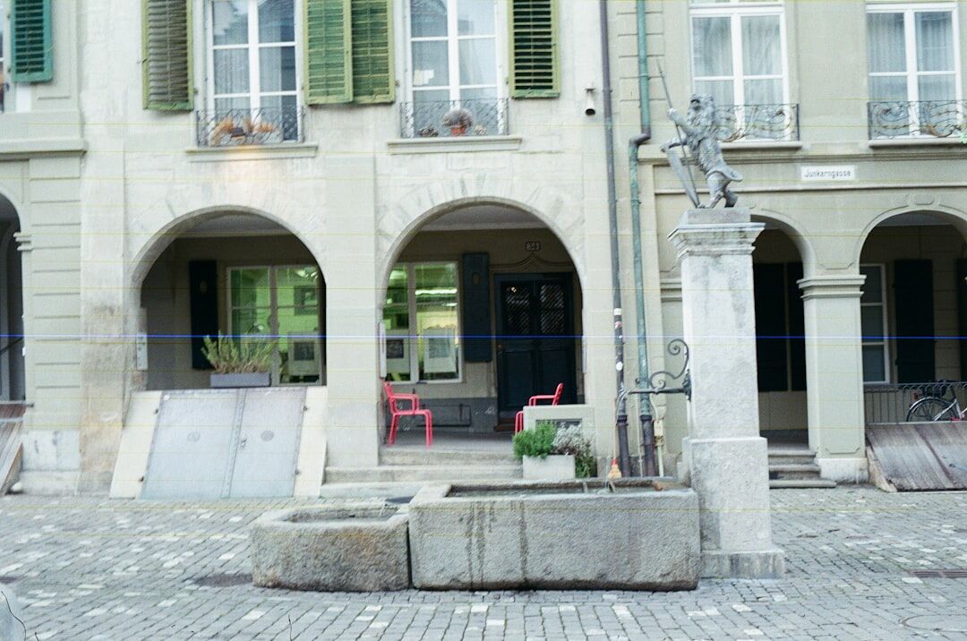 Historic town square with fountain and cafe tables
