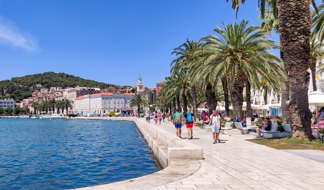 Wide shot of Split waterfront promenade Riva at dusk