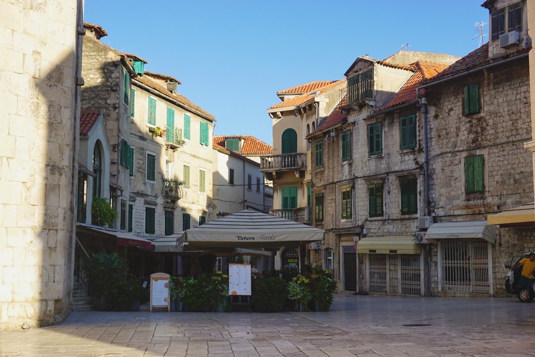 Children playing football in Split old town square