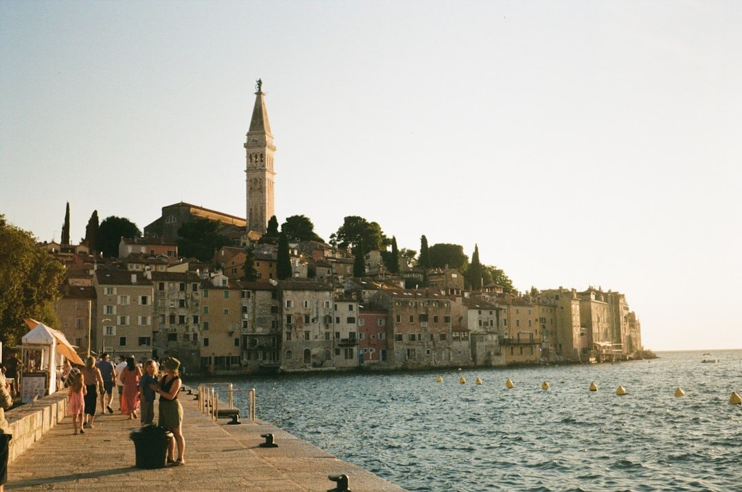 Rovinj pastel houses on peninsula with church tower