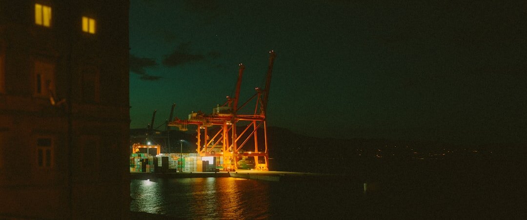 Rijeka harbor cranes and industrial waterfront at dusk