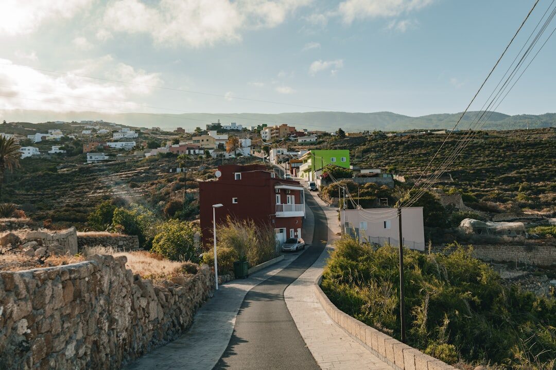 Steep cobblestone street with colorful houses in coastal town