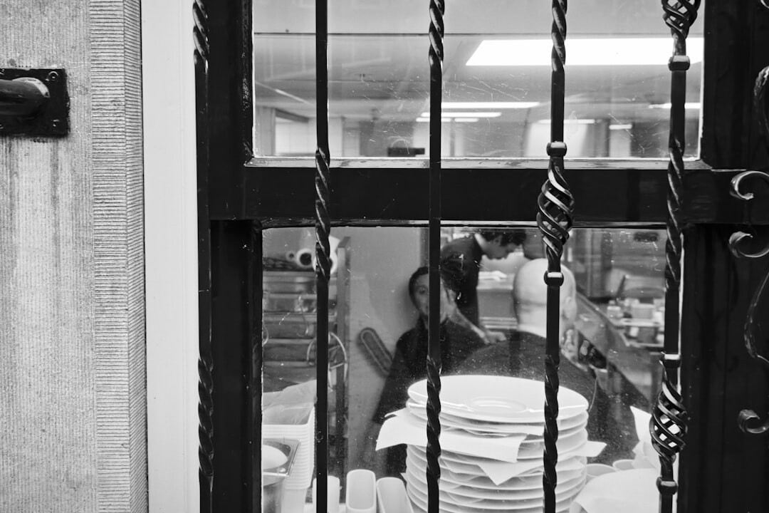 Chef plating fresh fish dish in restaurant kitchen